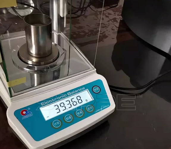 Cenosphere density sample measured on an electronic balance