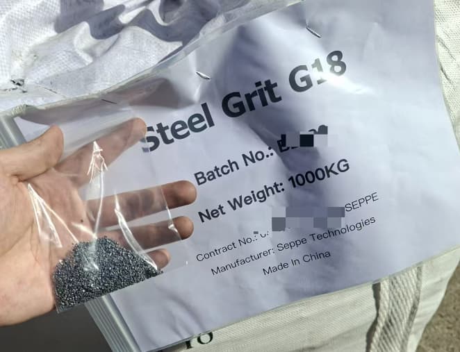 Steel Grit G18 packaging with an abrasive sample and batch label